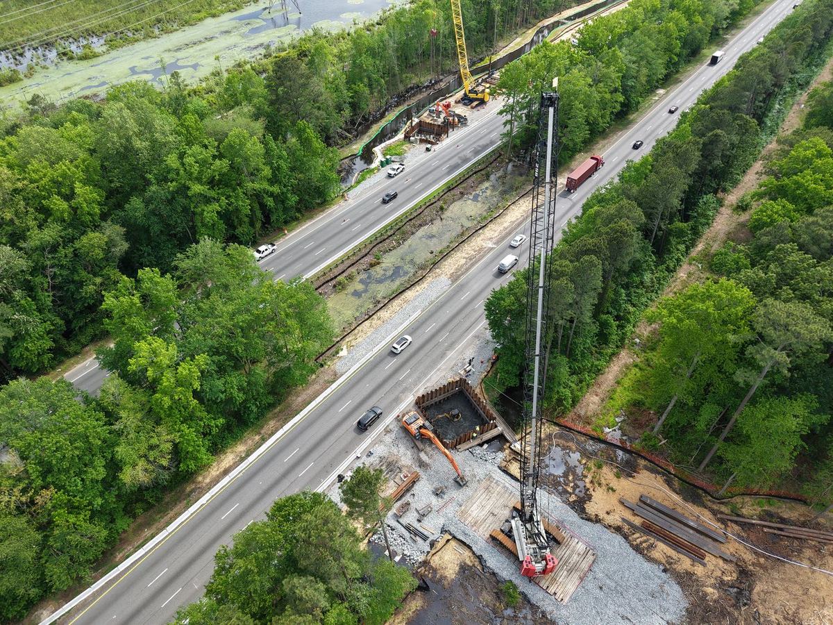 Aerial view of bridge work alongside live highway traffic