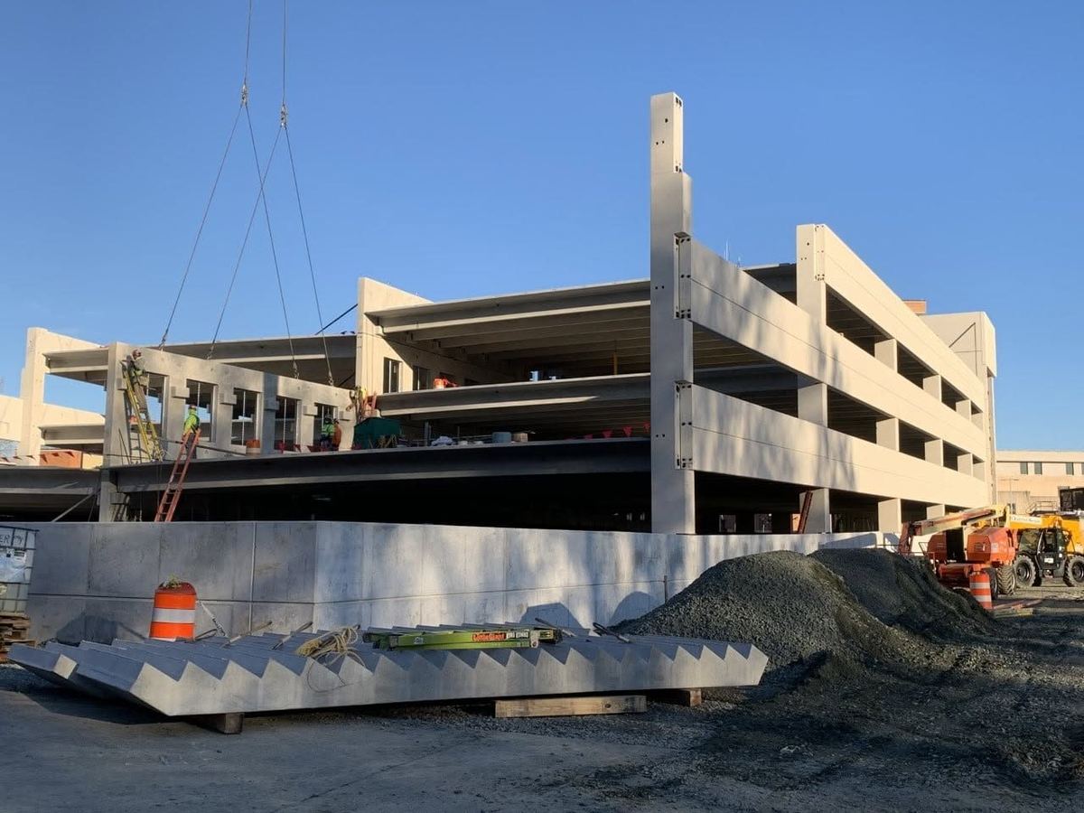 Precast double tees arriving on a trailer