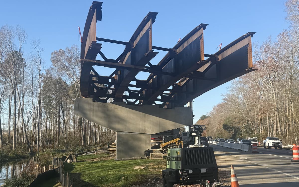 Crane setting a steel beam