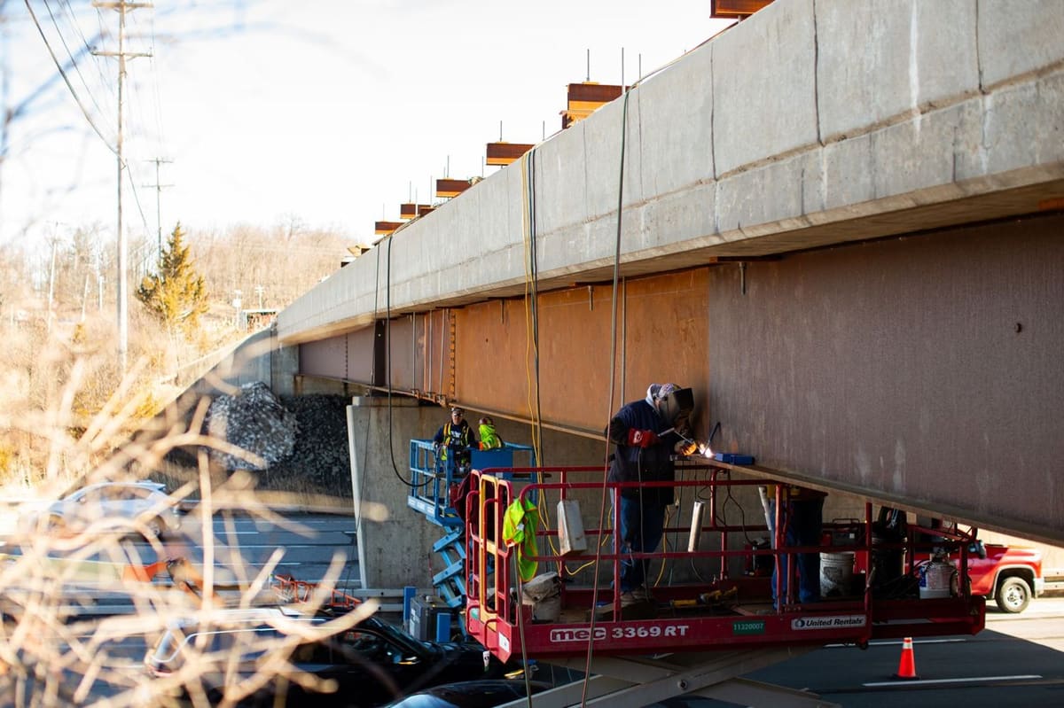 HSE ironworker heat straightening a bridge girder over a live highway