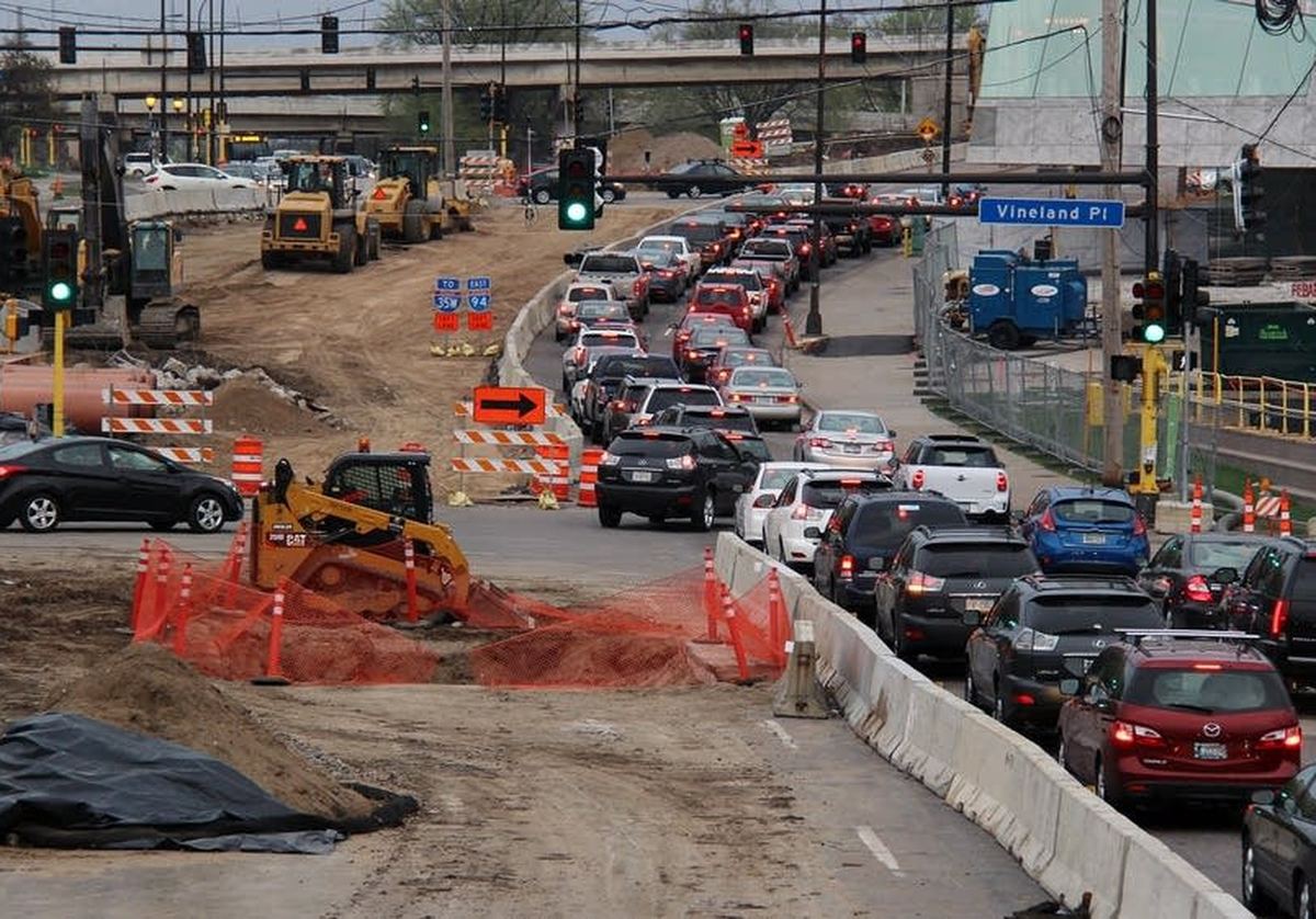 Traffic queued past a lane closure on an active roadway work zone