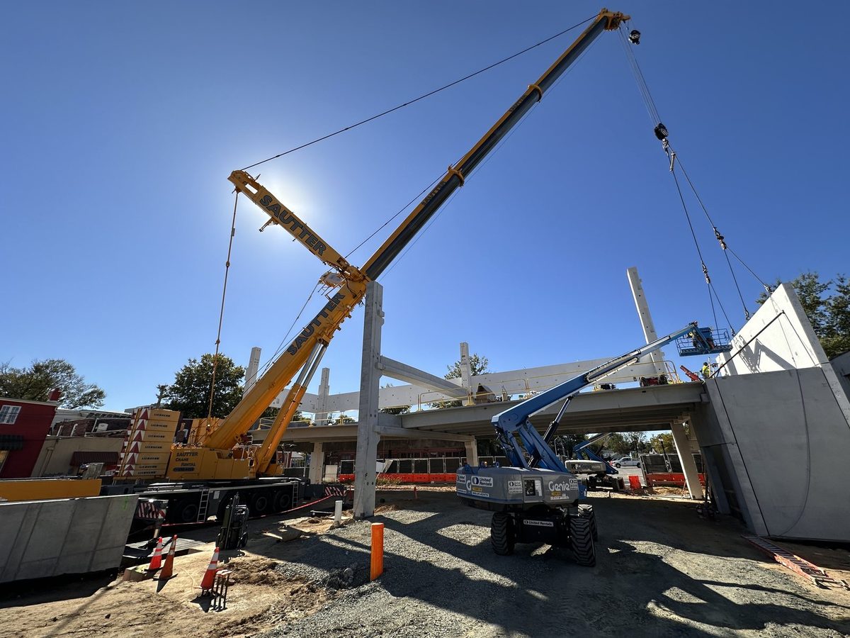 Sautter crane and HSE crew setting precast columns and framing on the Dover Mobility Parking Garage