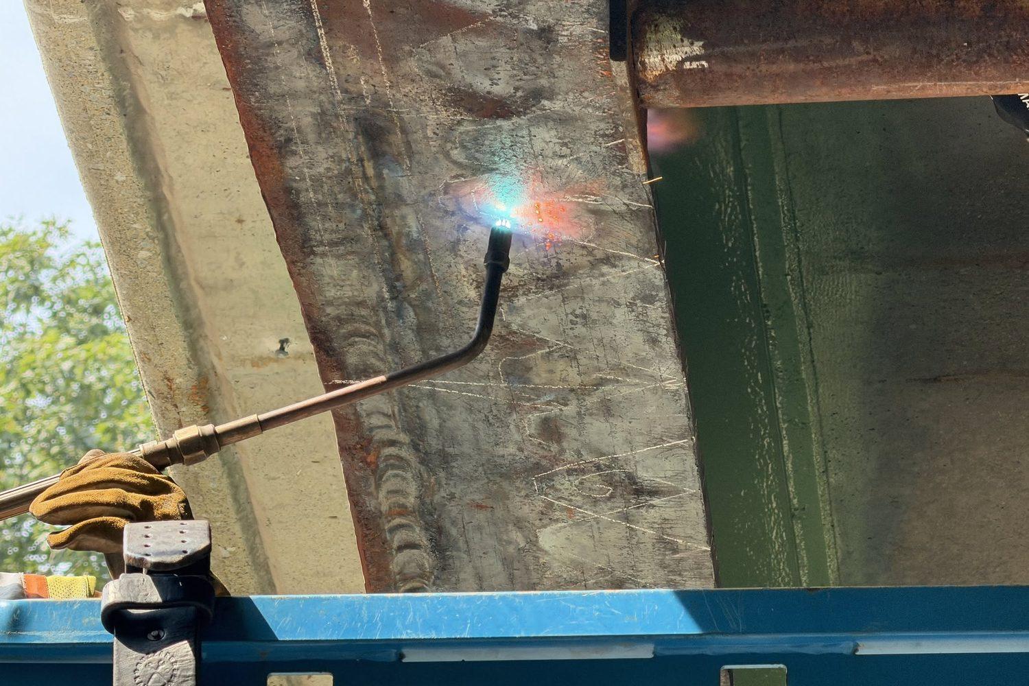 Heat straightening torch on a damaged girder flange