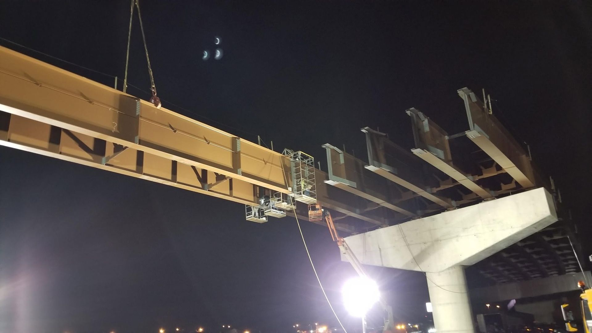 Crane setting a steel beam