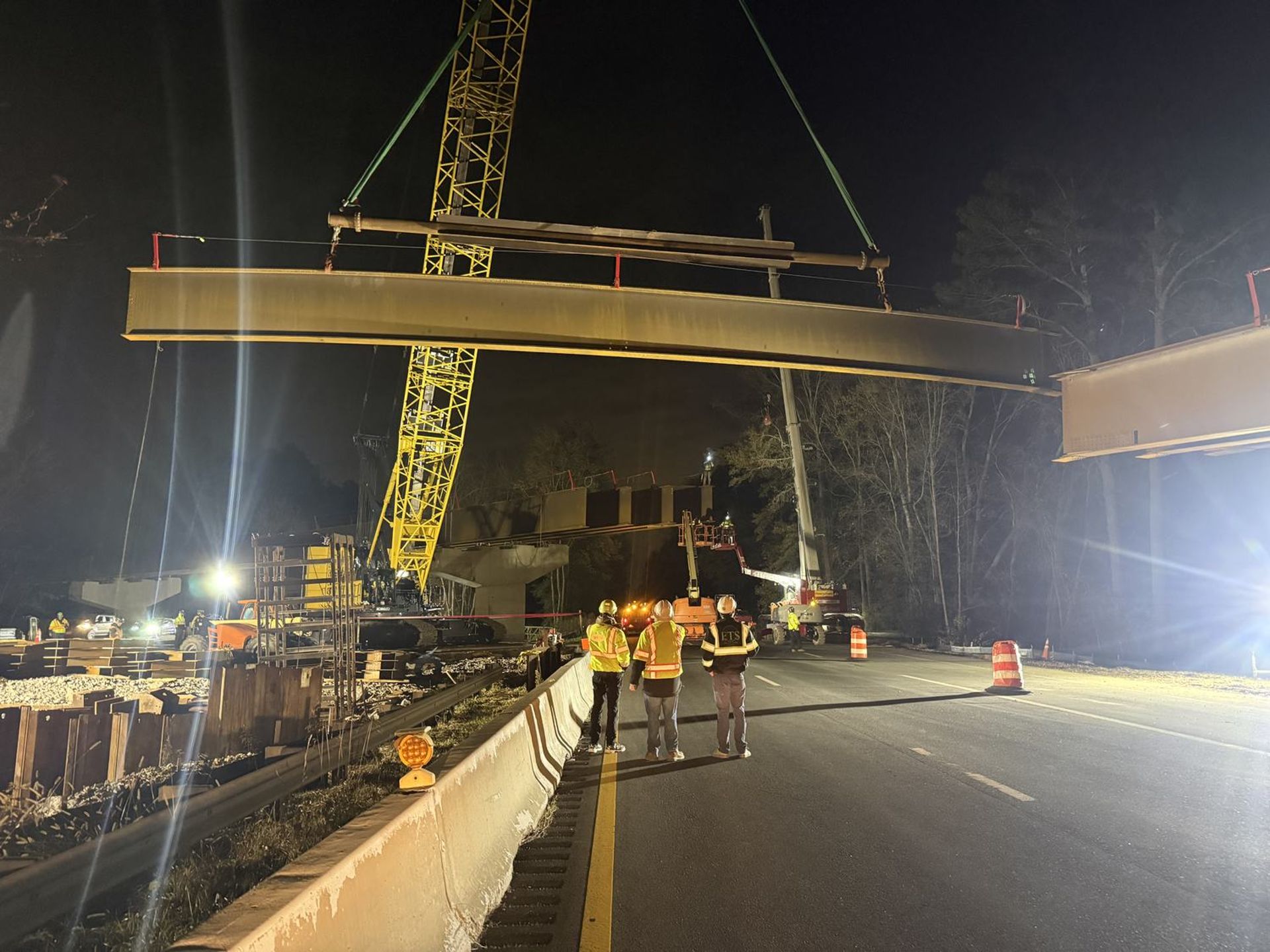 Night girder erection over a highway