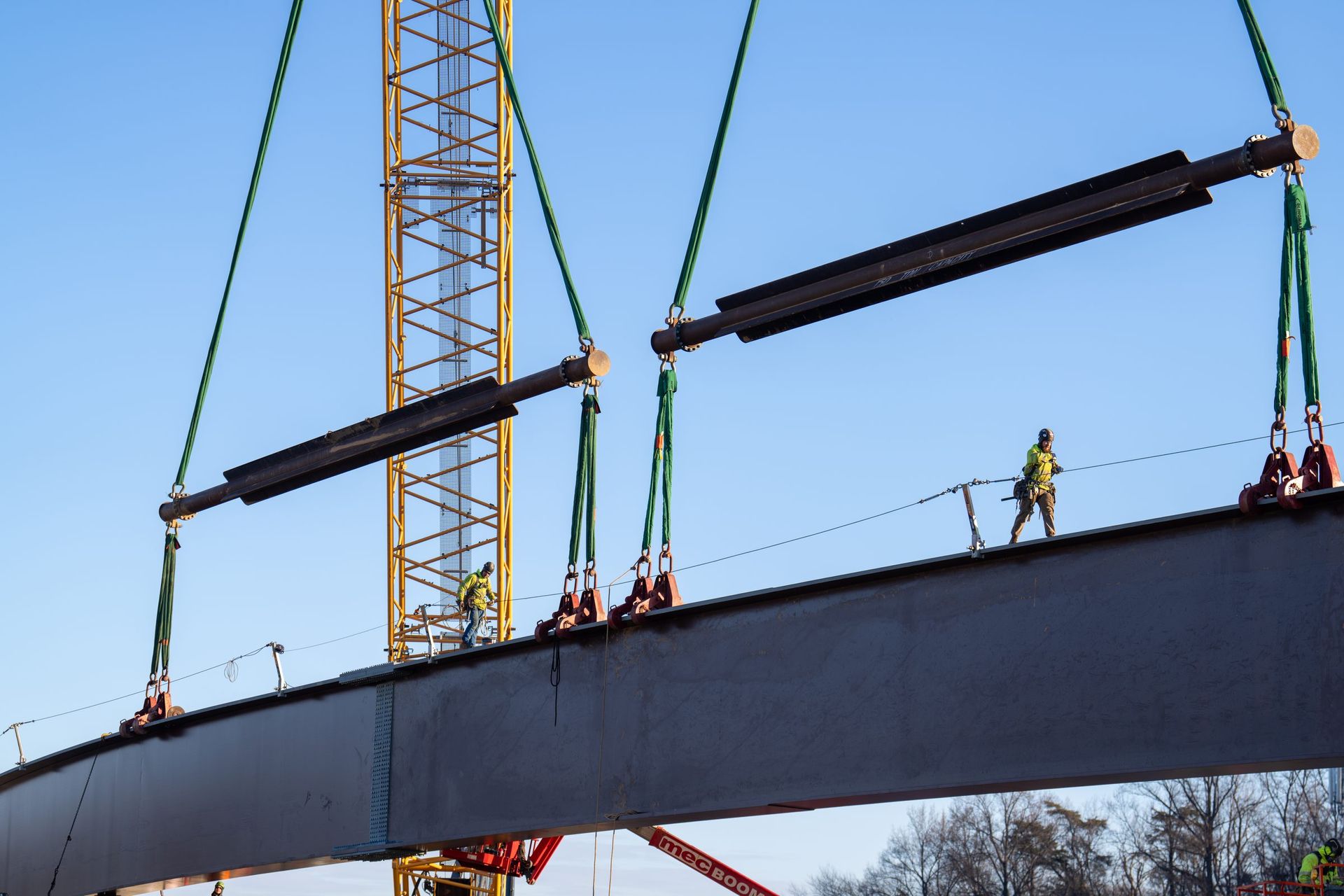HSE ironworkers on a curved plate girder lifted on twin spreader beams