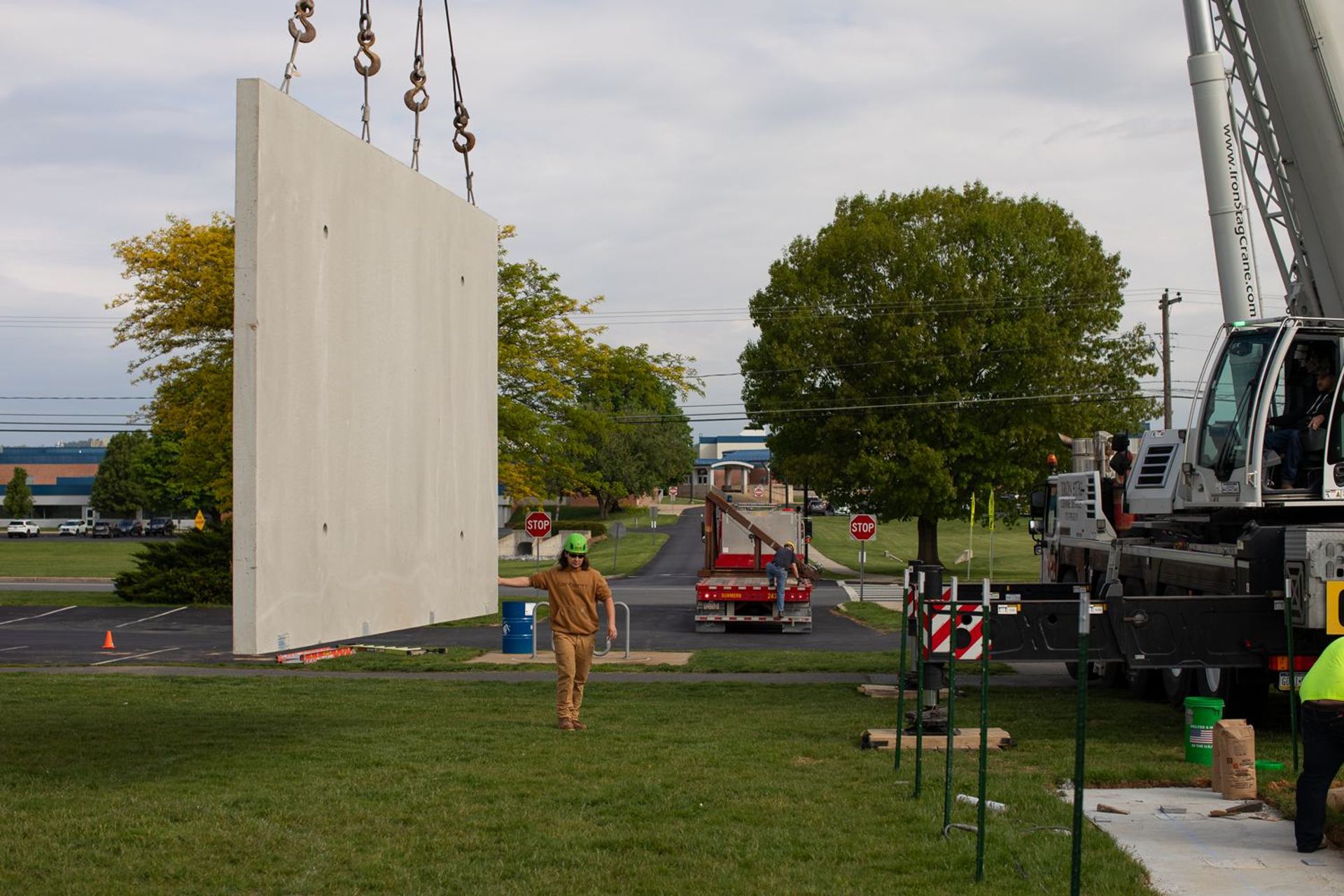 Precast concrete wall panel being lifted into place by crane