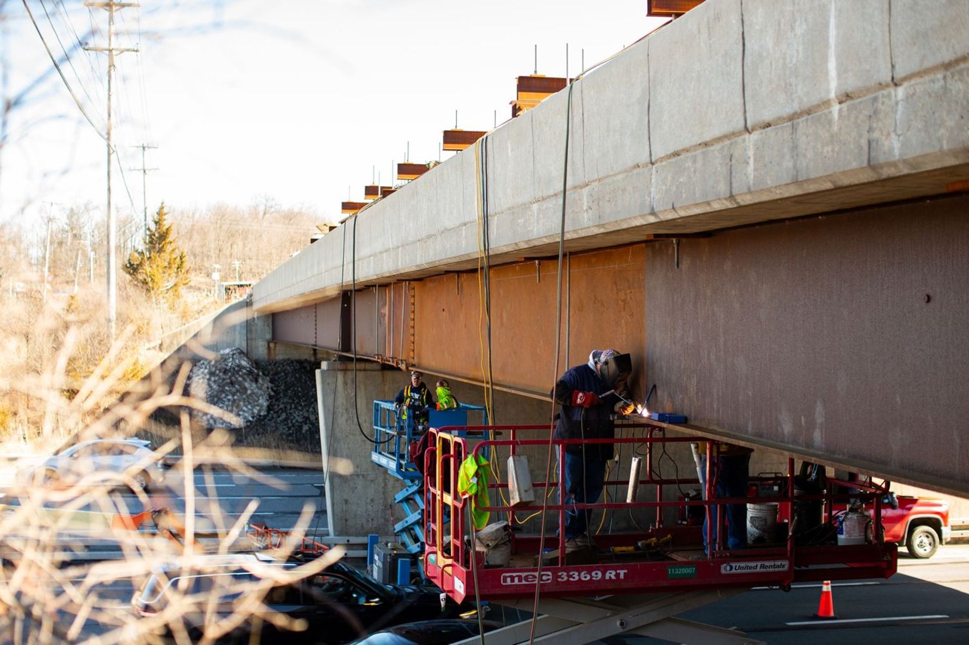 HSE ironworker heat straightening a struck girder over a live highway
