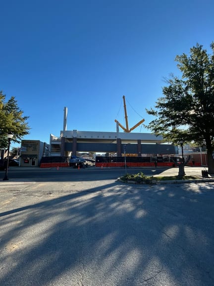 Street view of the Dover Mobility Parking Garage with brick faced precast and the crane boom above