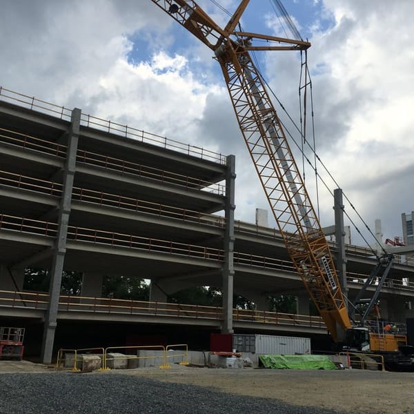 Crane erecting a precast parking garage