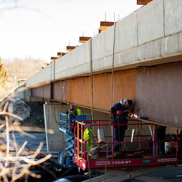 HSE ironworker heat straightening a struck girder over a live highway