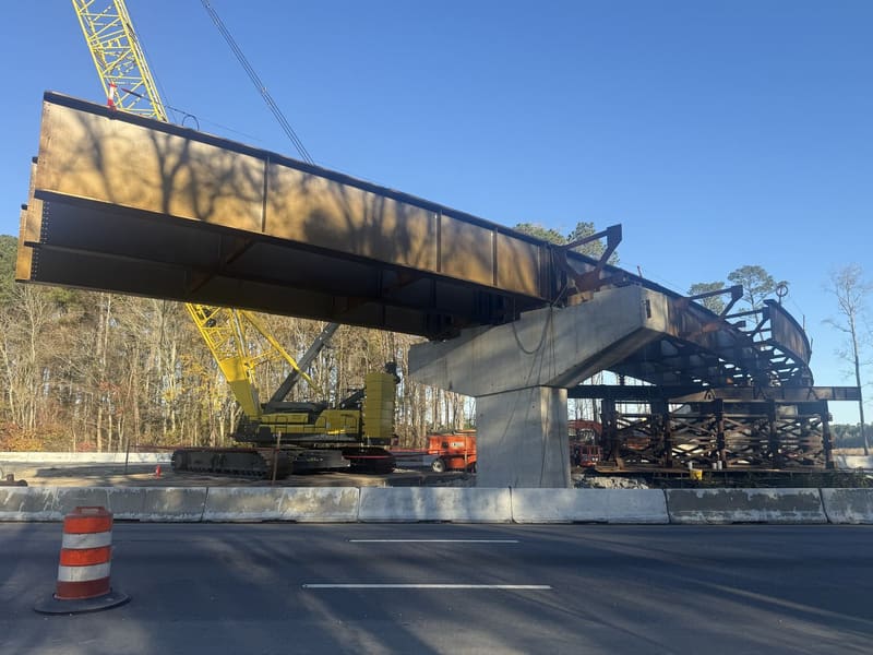 Steel girder being set on a pier