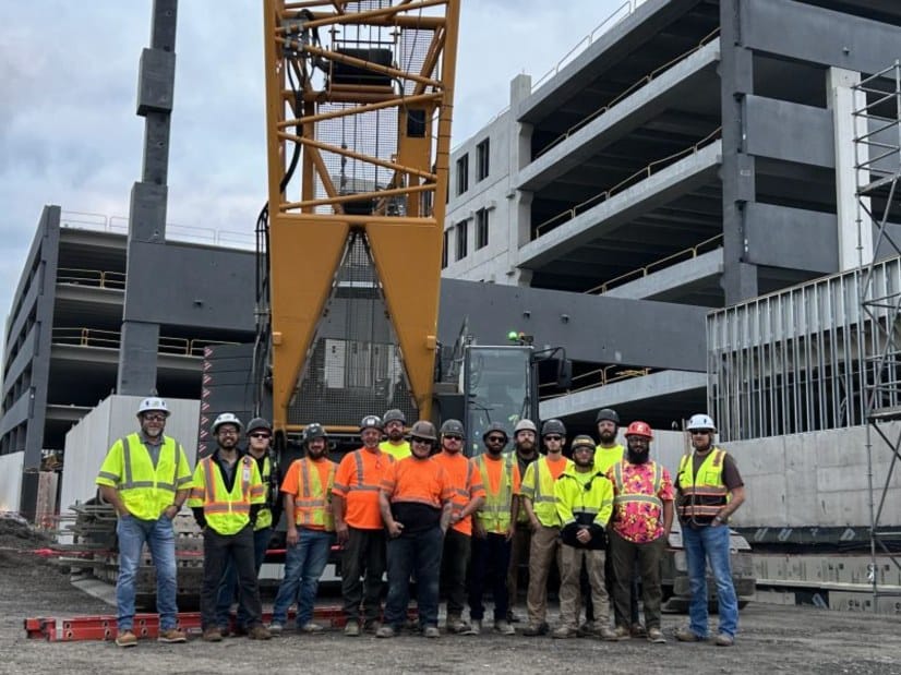The HSE Geisinger crew in front of the crawler crane and the new precast parking garage